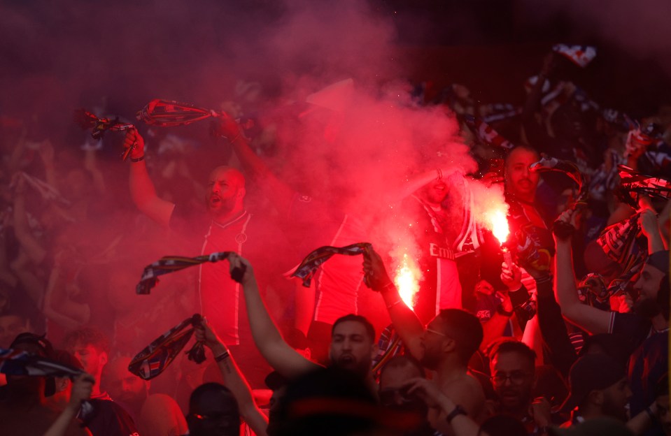 Paris Saint-Germain fans celebrating with flares.