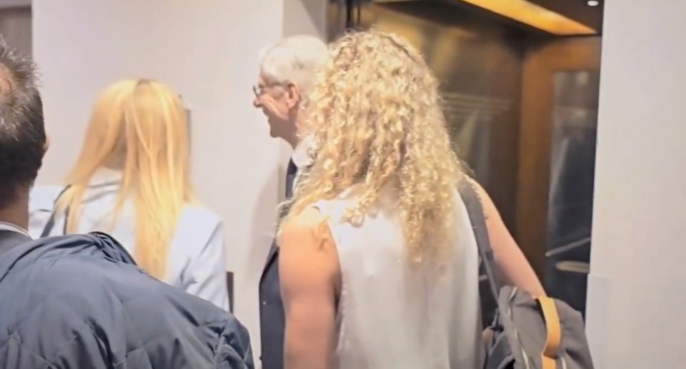 People walking down a hallway.