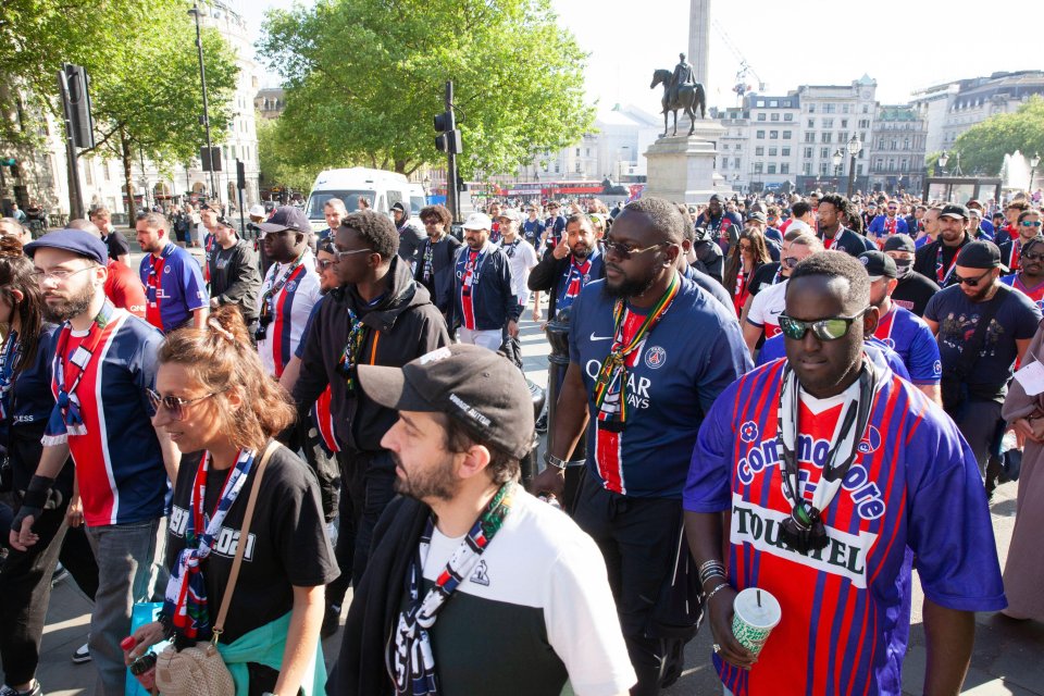 Paris Saint-Germain fans walking in Trafalgar Square before a Champions League match.