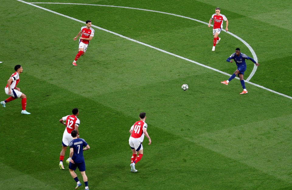 Ousmane Dembele scoring a goal during a soccer match.
