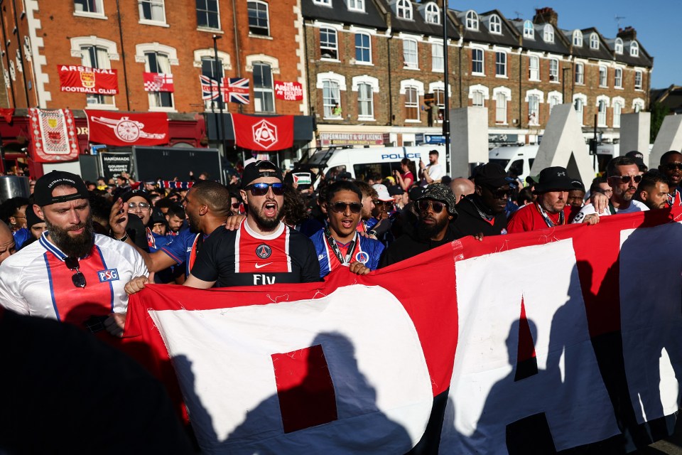 PSG supporters marching with a banner.