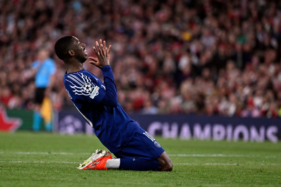 Ousmane Dembele of Paris Saint-Germain reacting during a Champions League match.