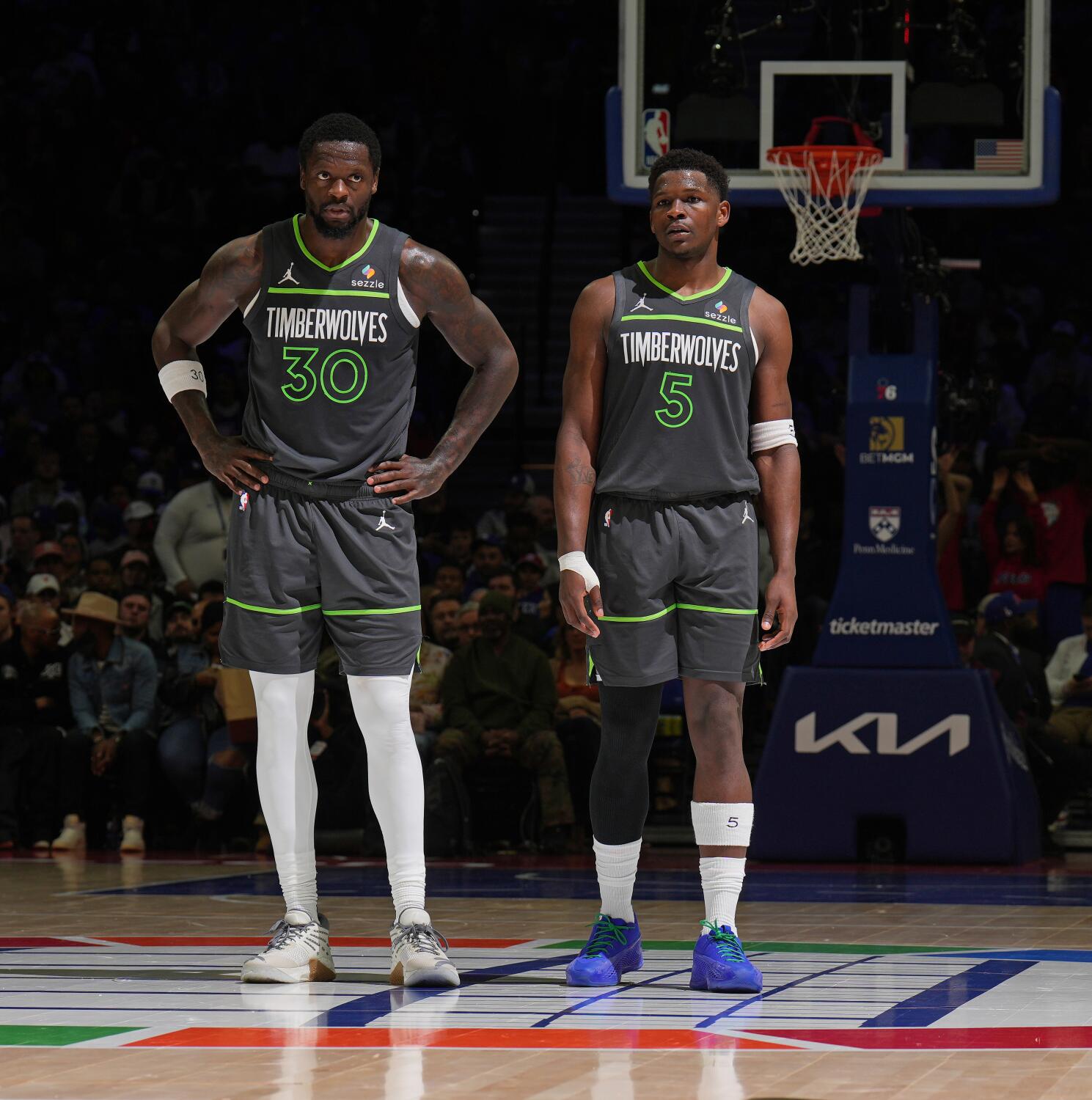 Julius Randle stands with his hands on his hips as he stands next to Timberwolves teammate Anthony Edwards while on court