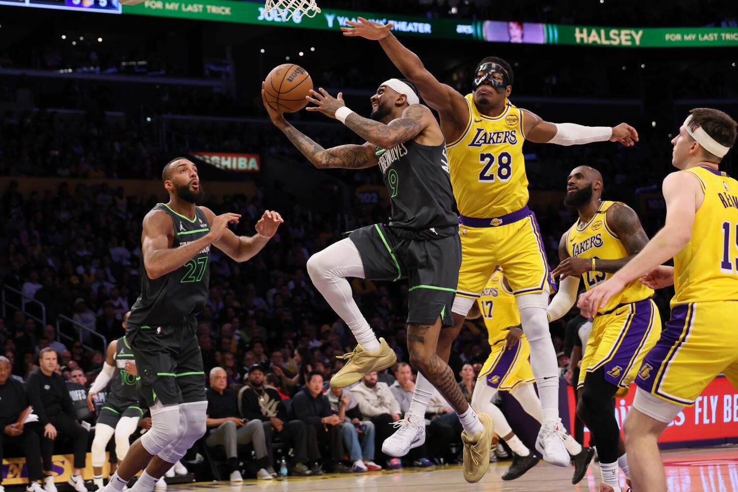 Timberwolves guard Nickeil Alexander-Walker drives past Lakers forward LeBron James and his teammates late in Game 5