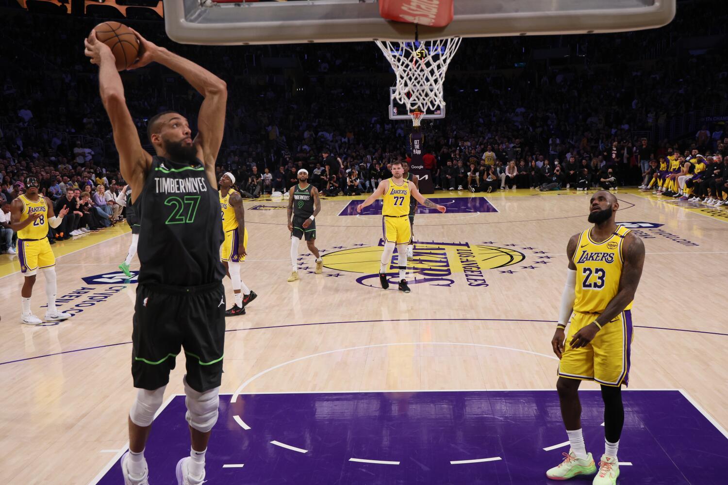 Lakers forward LeBron James looks frustrated while watching Timberwolves center Rudy Gobert dunk the ball during Game 5