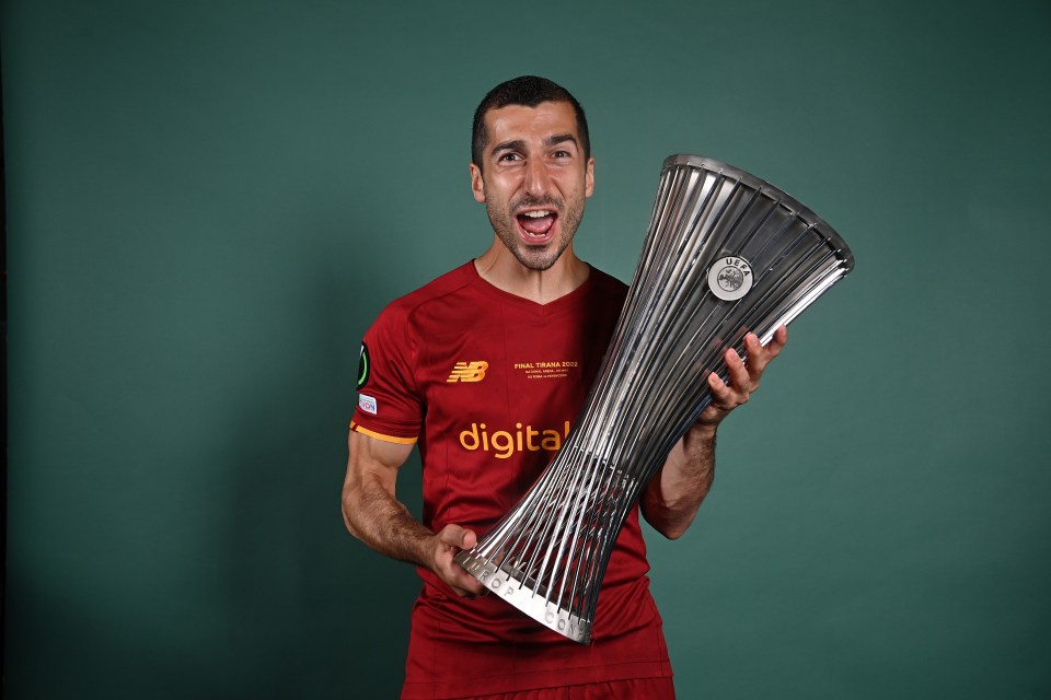 Henrikh Mkhitaryan holding the UEFA Europa Conference League trophy.