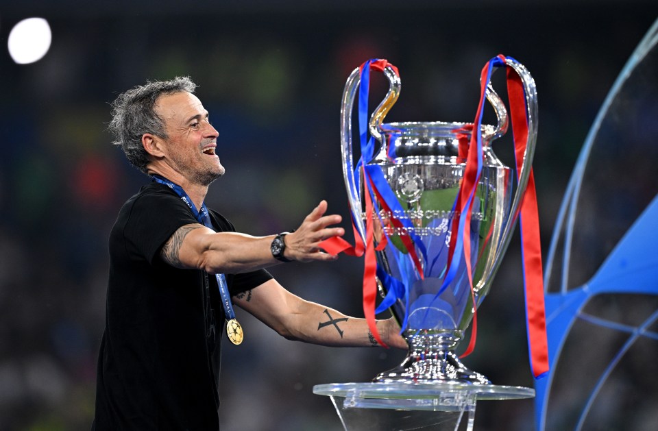 Luis Enrique, Paris Saint-Germain's head coach, with the UEFA Champions League trophy and winners medal.