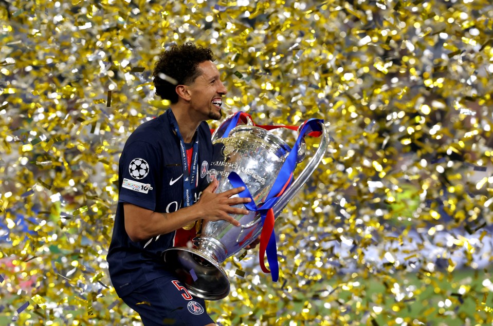 Marquinhos of Paris Saint-Germain holding the UEFA Champions League trophy.