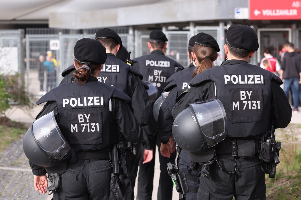 Police officers outside a stadium.