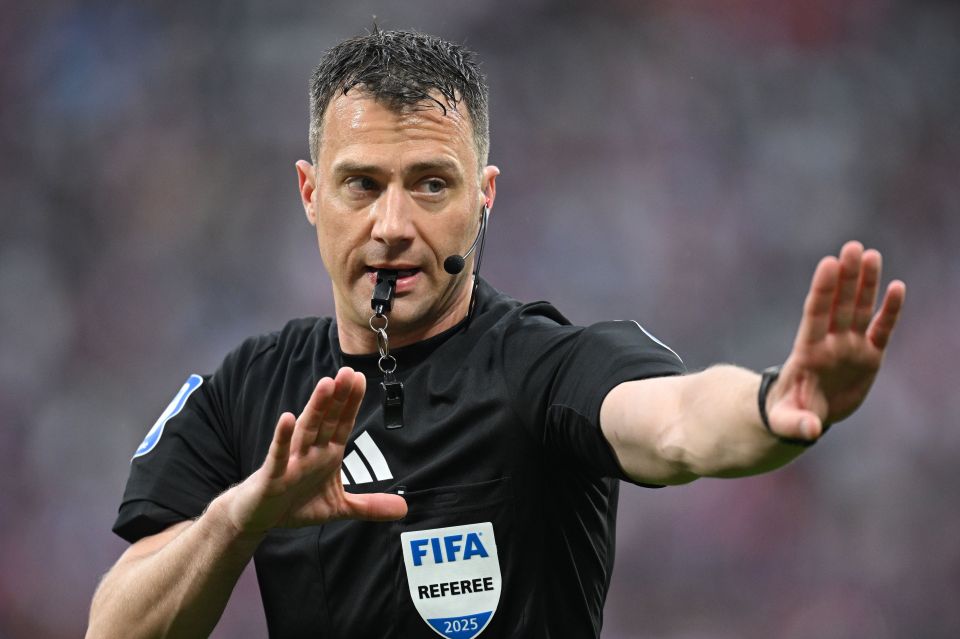 Referee Felix Zwayer signaling during a soccer game.