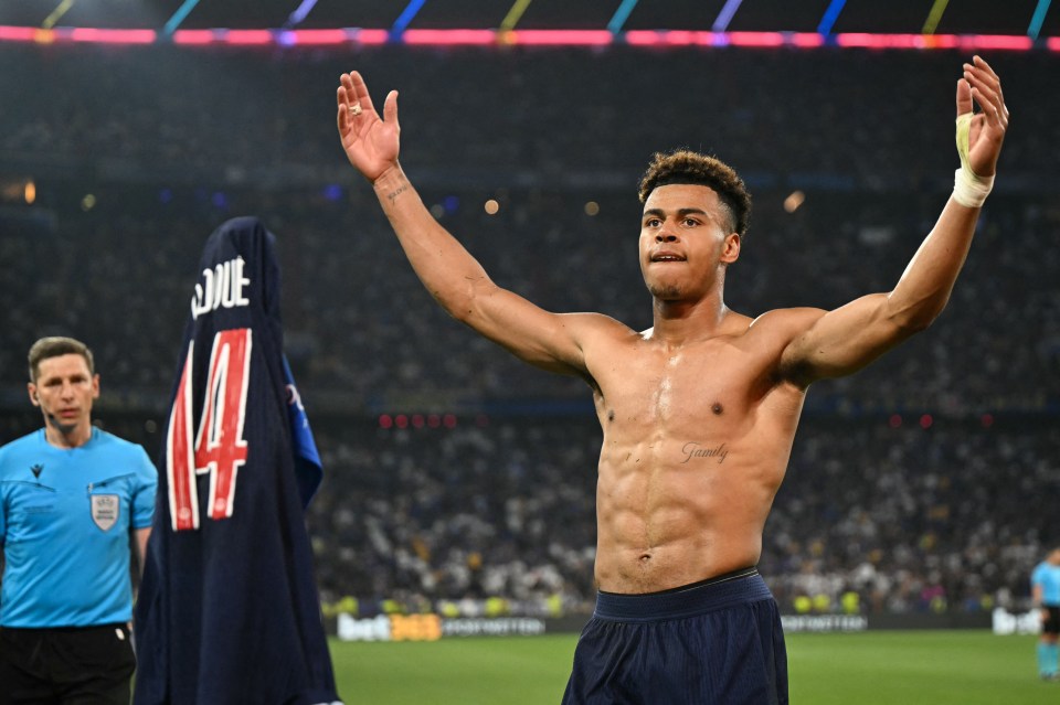 Shirtless soccer player celebrates scoring a goal.
