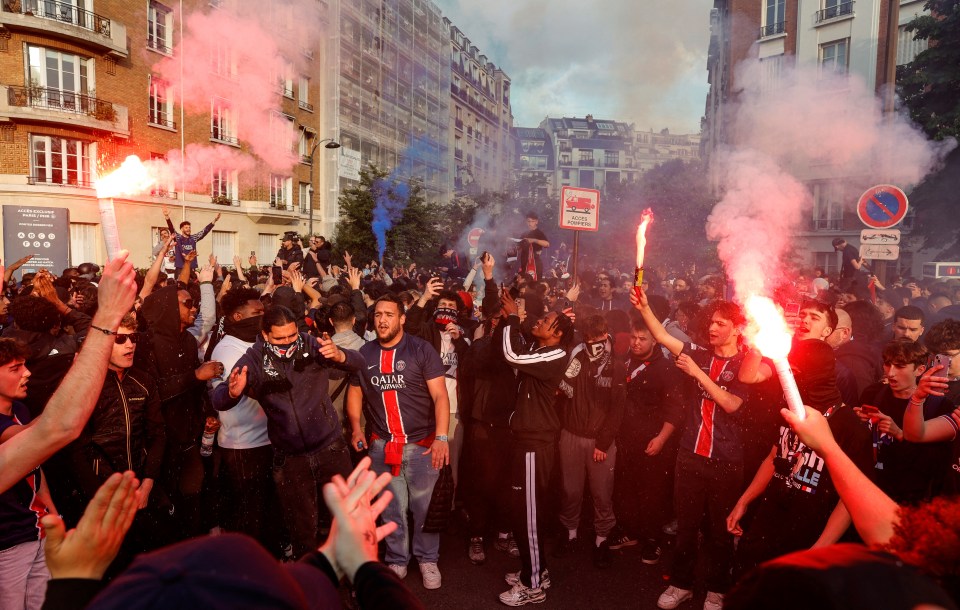 Paris Saint-Germain fans celebrating with flares.