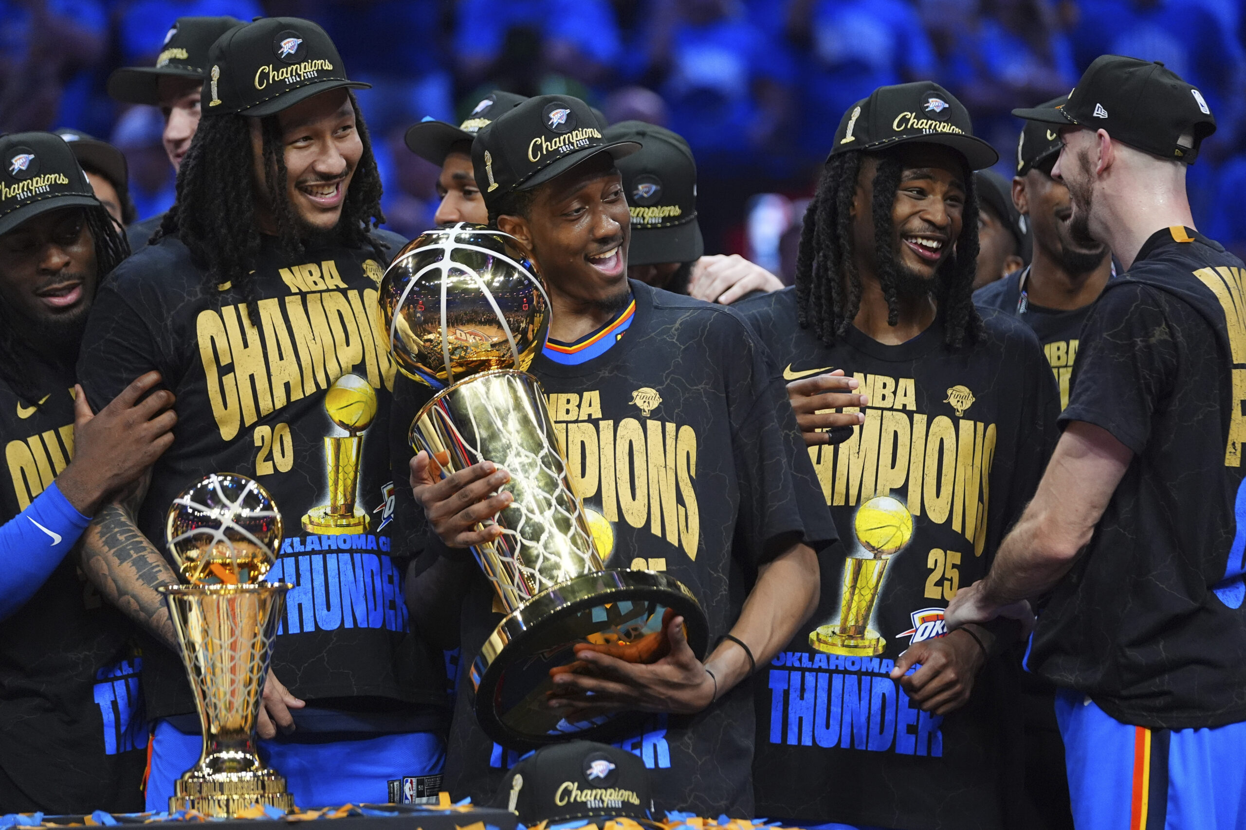Oklahoma City Thunder forward Jalen Williams (8) holds the Larry O'Brien Championship Trophy as he celebrates with his team after they won the NBA basketball championship with a Game 7 victory against the Indiana Pacers Sunday, June 22, 2025, in Oklahoma City. (AP Photo/Julio Cortez)
