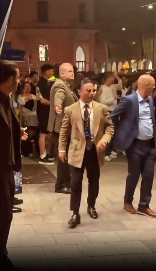 Salt Bae being escorted away from a venue.